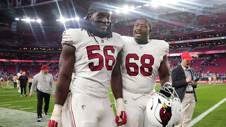 Arizona Cardinals defensive lineman Darius Robinson (56) walks off the field with teammate Kelvin Beachum (68) after their 30-17 win over the New England Patriots at State Farm Stadium on Dec. 15, 2024. Arizona Cardinals defensive lineman Darius Robinson (56) walks off the field with teammate Kelvin Beachum (68) after their 30-17 win over the New England Patriots at State Farm Stadium on Dec. 15, 2024.
