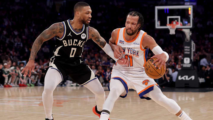 New York Knicks guard Jalen Brunson controls the ball against Milwaukee Bucks guard Damian Lillard.