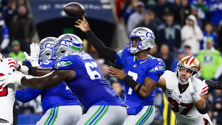 Oct 10, 2024; Seattle, Washington, USA; Seattle Seahawks quarterback Geno Smith (7) passes while under pressure from San Francisco 49ers defensive end Nick Bosa (97) during the fourth quarter at Lumen Field. Mandatory Credit: Joe Nicholson-Imagn Images