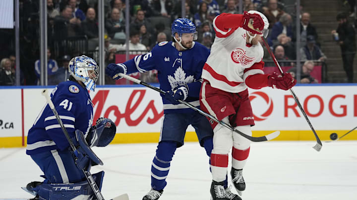 Nov 8, 2024; Toronto, Ontario, CAN; Detroit Red Wings forward Andrew Copp (18) tries to deflect a puck as Toronto Maple Leafs goaltender Anthony Stolarz (41) and defenceman Oliver Ekman-Larsson (95) defend during the second period at Scotiabank Arena. Mandatory Credit: John E. Sokolowski-Imagn Images