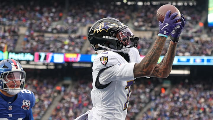 Dec 15, 2024; East Rutherford, New Jersey, USA; Baltimore Ravens wide receiver Rashod Bateman (7) catches a touchdown pass in front of New York Giants safety Dane Belton (24) during the first half at MetLife Stadium. Mandatory Credit: Vincent Carchietta-Imagn Images
