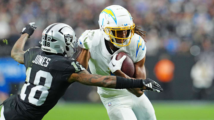 Las Vegas Raiders cornerback Jack Jones (18) looks to tackle Los Angeles Chargers wide receiver Quentin Johnston (1) during the second quarter at Allegiant Stadium. 