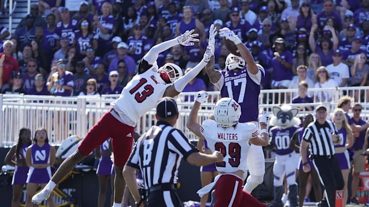 Aug 31, 2024; Evanston, Illinois, USA; Miami (Oh) Redhawks defensive back Raion Strader (13) breaks up a pass to Northwestern Wildcats wide receiver Bryce Kirtz (17) during the first half at Lanny and Sharon Martin Stadium. Mandatory Credit: David Banks-Imagn Images