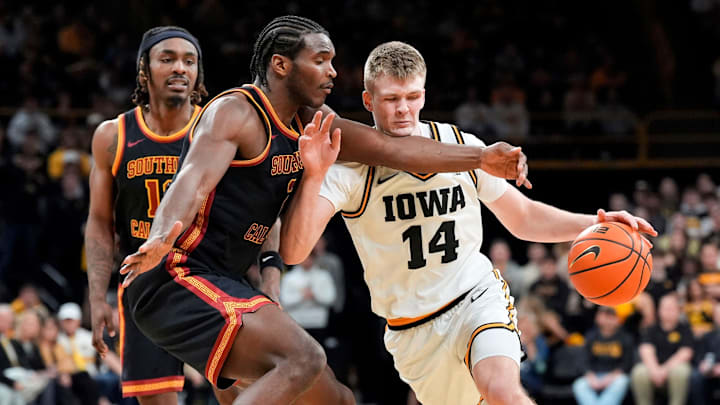 Iowa guard Bennett Stirtz (14) attempts to dribble around USC forward Ezra Ausar (2) Jan. 28, 2026 at Carver-Hawkeye Arena in Iowa City, Iowa.