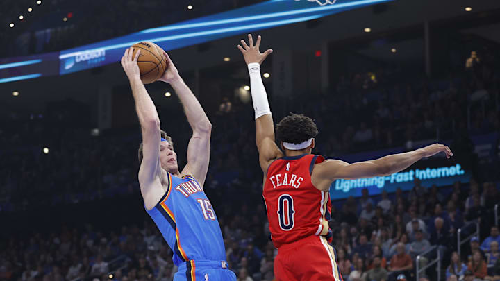 Nov 2, 2025; Oklahoma City, Oklahoma, USA; Oklahoma City Thunder center Branden Carlson (15) goes to the basket as New Orleans Pelicans guard Jeremiah Fears (0) defends during the first quarter at Paycom Center. Mandatory Credit: Alonzo Adams-Imagn Images