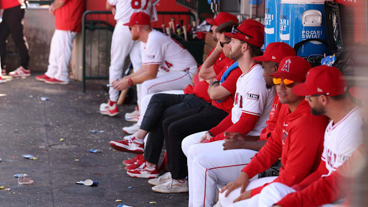 Sep 29, 2024; Anaheim, California, USA;  Los Angeles Angels left fielder Taylor Ward (3, fourth from right) watches a game from a dugout during the ninth inning against the Texas Rangers at Angel Stadium. Mandatory Credit: Kiyoshi Mio-Imagn Images