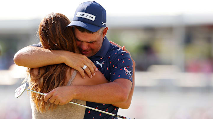 Gary Woodland embraces wife Gabby Granado on the 18th green after an emotional win at the Texas Children's Houston Open.