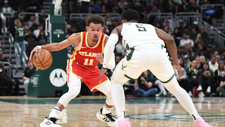 Oct 29, 2023; Milwaukee, Wisconsin, USA; Atlanta Hawks guard Trae Young (11) brings the ball up the court against Milwaukee Bucks guard Malik Beasley (5) in the second half at Fiserv Forum. Mandatory Credit: Michael McLoone-Imagn Images