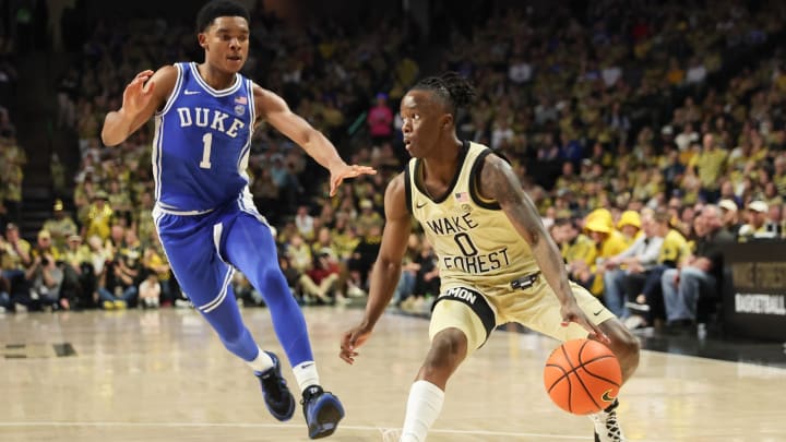 Feb 24, 2024; Winston-Salem, North Carolina, USA;  Wake Forest Demon Deacons guard Kevin Miller (0) drives the ball against Duke Blue Devils guard Caleb Foster (1) during the first half at Lawrence Joel Veterans Memorial Coliseum. Mandatory Credit: Cory Knowlton-USA TODAY Sports