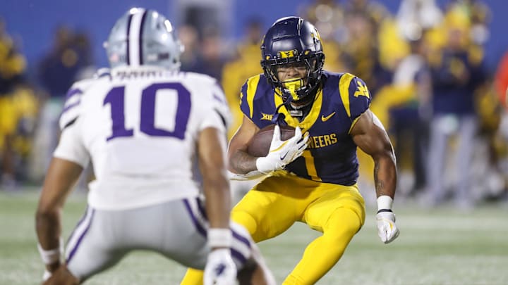 Oct 19, 2024; Morgantown, West Virginia, USA; West Virginia Mountaineers running back Jahiem White (1) runs during the second quarter against the Kansas State Wildcats at Mountaineer Field at Milan Puskar Stadium. Mandatory Credit: Ben Queen-Imagn Images