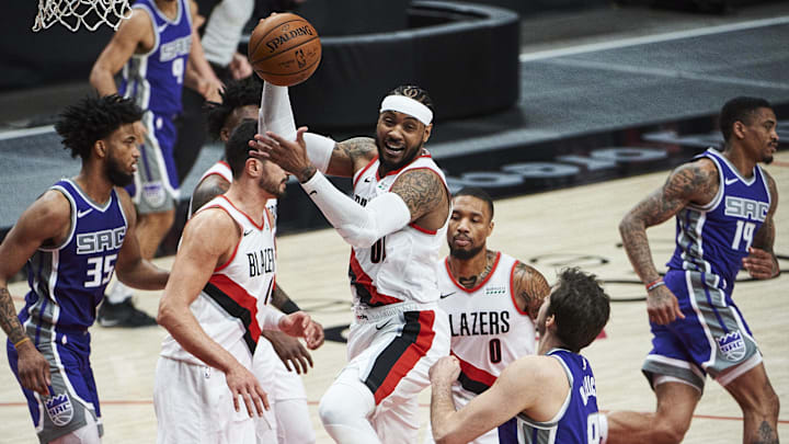 Mar 4, 2021; Portland, Oregon, USA; Portland Trail Blazers forward Carmelo Anthony (00) grabs a rebound against Sacramento Kings forward Nemanja Bjelica (8) during the first half at Moda Center. Mandatory Credit: Troy Wayrynen-Imagn Images