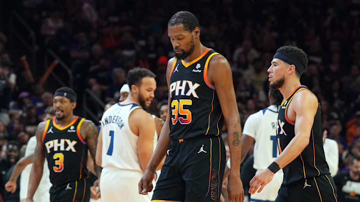Apr 26, 2024; Phoenix, Arizona, USA; Phoenix Suns guard Bradley Beal (3) and Phoenix Suns forward Kevin Durant (35) and Phoenix Suns guard Devin Booker (1) react while Minnesota Timberwolves celebrate during the second half of game three of the first round for the 2024 NBA playoffs at Footprint Center. Mandatory Credit: Joe Camporeale-Imagn Images