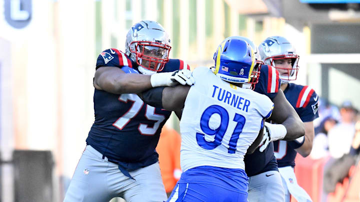 Nov 17, 2024; Foxborough, Massachusetts, USA; New England Patriots offensive tackle Demontrey Jacobs (75) blocks Los Angeles Rams defensive tackle Kobie Turner (91) during the first half at Gillette Stadium. Mandatory Credit: Eric Canha-Imagn Images