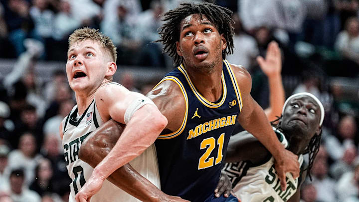 Michigan forward Morez Johnson Jr. (21), center, battle for position against Michigan State forward Jaxon Kohler (0) and guard Kur Teng (2) during the second half at Breslin Center in East Lansing on Friday, Jan. 30, 2026.