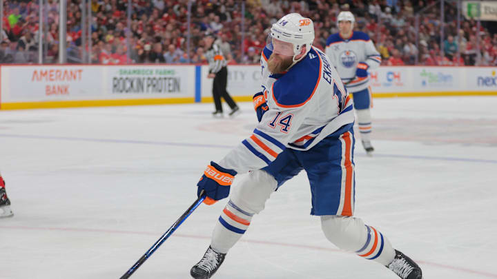 Feb 27, 2025; Sunrise, Florida, USA; Edmonton Oilers defenseman Mattias Ekholm (14) shoots the puck against the Florida Panthers during the first period at Amerant Bank Arena. Mandatory Credit: Sam Navarro-Imagn Images