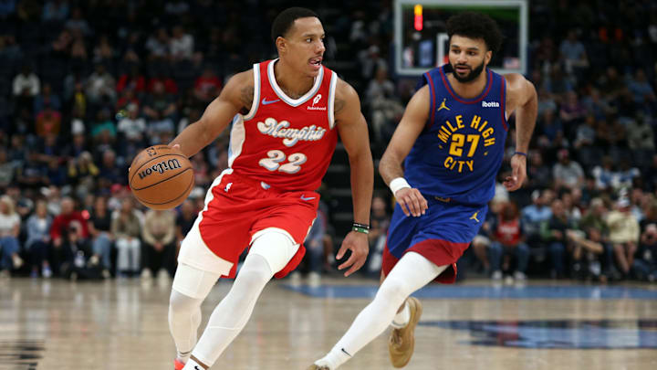 Memphis Grizzlies guard Desmond Bane (22) dribbles as Denver Nuggets guard Jamal Murray (27) defends during the second half at FedExForum. Mandatory Credit: Petre Thomas-Imagn Images