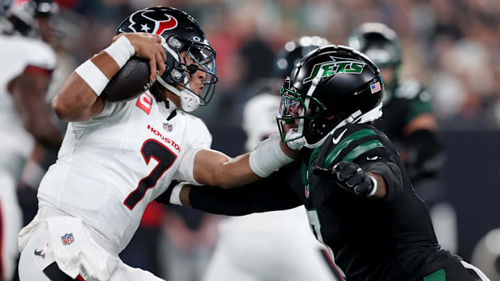 Oct 31, 2024; East Rutherford, New Jersey, USA; Houston Texans quarterback C.J. Stroud (7) is pressured by New York Jets defensive end Haason Reddick (7) during the first quarter at MetLife Stadium. Mandatory Credit: Brad Penner-Imagn Images