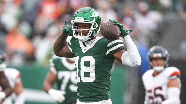 Sep 29, 2024; East Rutherford, New Jersey, USA; New York Jets wide receiver Mike Williams (18) celebrates a first down reception during the second half against the Denver Broncos at MetLife Stadium. Mandatory Credit: Vincent Carchietta-Imagn Images