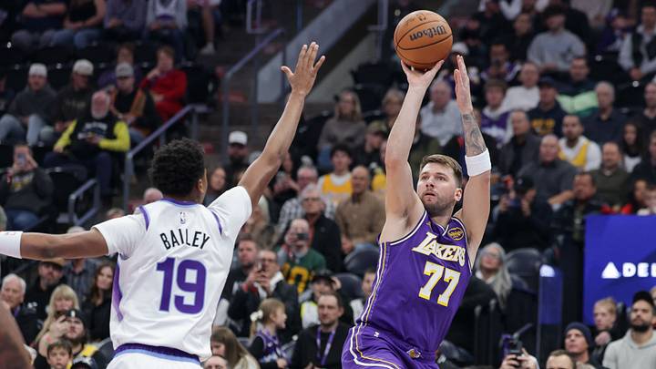 Dec 18, 2025; Salt Lake City, Utah, USA;  Los Angeles Lakers forward/guard Luka Doncic (77) shoots over Utah Jazz forward Ace Bailey (19) during the first quarter at Delta Center. Mandatory Credit: Chris Nicoll-Imagn Images