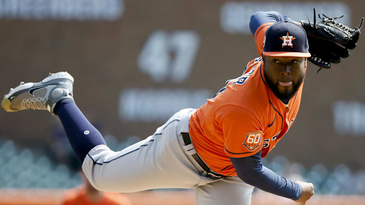 Cristian Javier follows through on a pitch with his tongue out. 