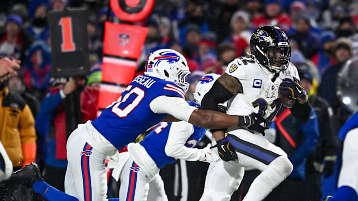 Baltimore Ravens running back Derrick Henry carries the ball as Buffalo Bills defensive end Greg Rousseau attempts a tackle. Mandatory Credit: Mark Konezny-Imagn Images