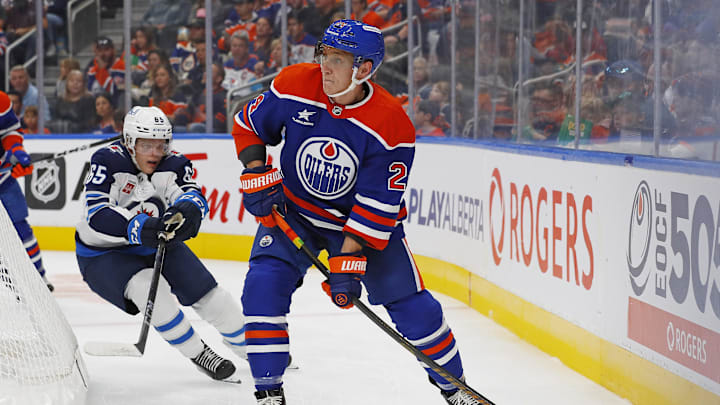 Sep 22, 2024; Edmonton, Alberta, CAN; Edmonton Oilers defensemen Travis Dermott (24) makes a pass in front of Winnipeg Jets forward Markus Loponen (65) during the second period at Rogers Place. Mandatory Credit: Perry Nelson-Imagn Images Sep 22, 2024; Edmonton, Alberta, CAN; Edmonton Oilers defensemen Travis Dermott (24) makes a pass in front of Winnipeg Jets forward Markus Loponen (65) during the second period at Rogers Place. Mandatory Credit: Perry Nelson-Imagn Images