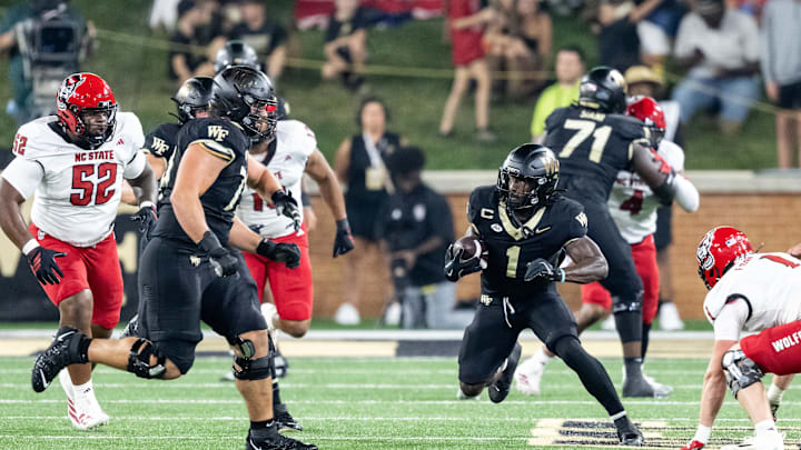 Sep 11, 2025; Winston-Salem, North Carolina, USA;  Wake Forest Demon Deacons running back Demond Claiborne (1) runs the ball in the first half against the North Carolina State Wolfpack at Allegacy Federal Credit Union Stadium. Mandatory Credit: Luke Jamroz-Imagn Images