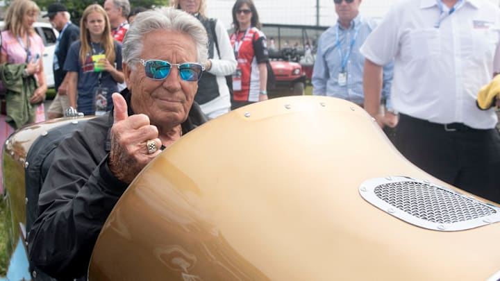 May 28, 2023; Indianapolis, Indiana, USA; Former driver Mario Andretti gives a thumbs up as he drives a historic car Sunday, May 28, 2023, during the 107th running of the Indianapolis 500 at Indianapolis Motor Speedway. Mandatory Credit: Gary Mook-Imagn Images
