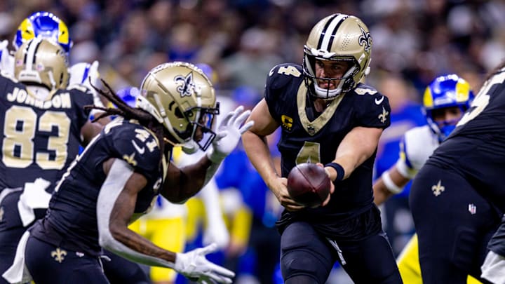 Dec 1, 2024; New Orleans, Louisiana, USA;  New Orleans Saints quarterback Derek Carr (4) hands of to running back Alvin Kamara (41) against the Los Angeles Rams during the first half at Caesars Superdome.  