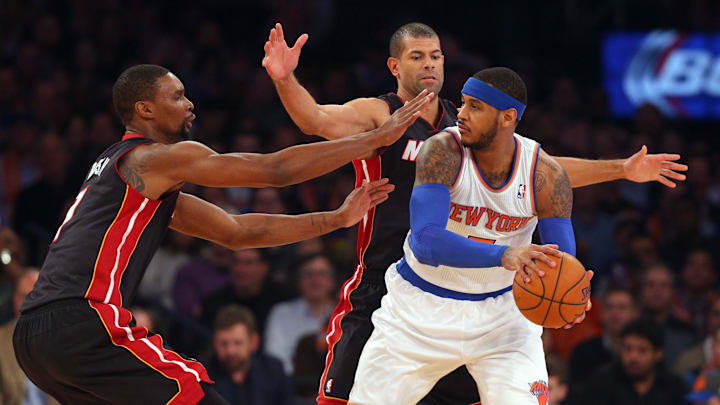 Feb 1, 2014; New York, NY, USA; New York Knicks small forward Carmelo Anthony (7) is defended by Miami Heat center Chris Bosh (1) and small forward Shane Battier (31) during the first period of a game at Madison Square Garden. Mandatory Credit: Brad Penner-Imagn Images