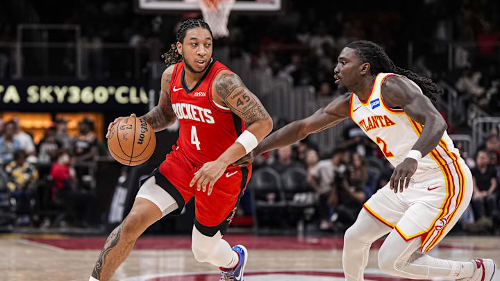 Oct 16, 2025; Atlanta, Georgia, USA; Houston Rockets guard JD Davison (4) dribbles defended by Atlanta Hawks guard Keaton Wallace (2) during the second half at State Farm Arena. Mandatory Credit: Dale Zanine-Imagn Images