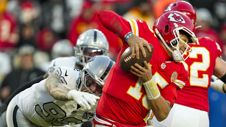 Nov 29, 2024; Kansas City, Missouri, USA; Kansas City Chiefs quarterback Patrick Mahomes (15) scrambles from Las Vegas Raiders defensive end Maxx Crosby (98) during the second half at GEHA Field at Arrowhead Stadium. Mandatory Credit: Jay Biggerstaff-Imagn Images