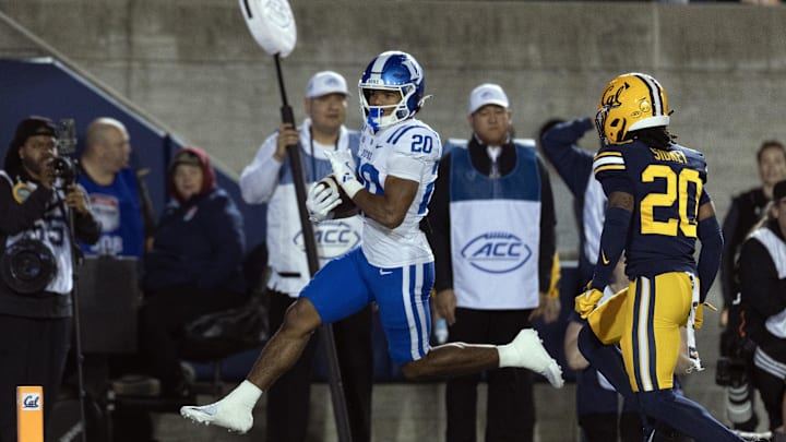 Oct 4, 2025; Berkeley, California, USA; Duke Blue Devils running back Nate Sheppard (20) high steps into the end zone for a touchdown ahead of California Golden Bears defensive back Cam Sidney (20) during the first quarter at California Memorial Stadium. Mandatory Credit: D. Ross Cameron-Imagn Images Oct 4, 2025; Berkeley, California, USA; Duke Blue Devils running back Nate Sheppard (20) high steps into the end zone for a touchdown ahead of California Golden Bears defensive back Cam Sidney (20) during the first quarter at California Memorial Stadium. Mandatory Credit: D. Ross Cameron-Imagn Images
