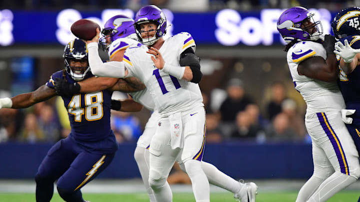 Oct 23, 2025; Inglewood, California, USA; Minnesota Vikings quarterback Carson Wentz (11) throws the ball against the Los Angeles Chargers during the first half at SoFi Stadium. Mandatory Credit: Gary A. Vasquez-Imagn Images