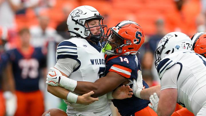 Sep 5, 2026; Syracuse, New York, USA; Syracuse Orange linebacker Keyshawn Johnson (14) sacks New Hampshire Wildcats quarterback Brooks Bentley (7) causing a fumble during the first half at the JMA Wireless Dome. Mandatory Credit: Rich Barnes-Imagn Images Sep 5, 2026; Syracuse, New York, USA; Syracuse Orange linebacker Keyshawn Johnson (14) sacks New Hampshire Wildcats quarterback Brooks Bentley (7) causing a fumble during the first half at the JMA Wireless Dome. Mandatory Credit: Rich Barnes-Imagn Images