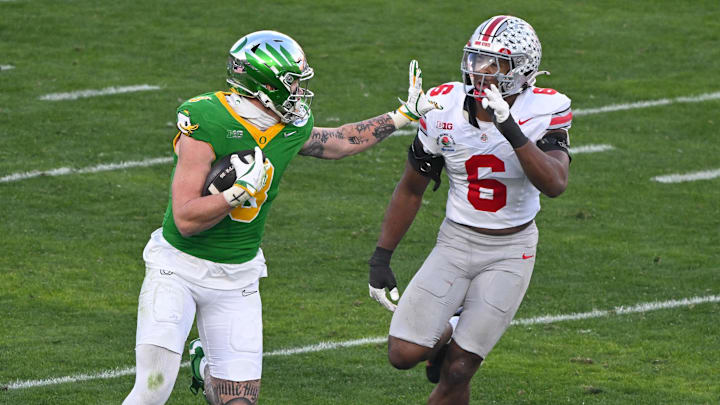 Jan 1, 2025; Pasadena, CA, USA; Oregon Ducks tight end Terrance Ferguson (3) stiff arms Ohio State Buckeyes safety Lathan Ransom (8) during a third quarter pass play at Rose Bowl Stadium. Mandatory Credit: Robert Hanashiro-Imagn Images