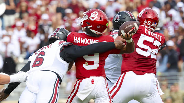 Oct 19, 2024; Norman, Oklahoma, USA; South Carolina Gamecocks edge Dylan Stewart (6) hits Oklahoma Sooners quarterback Michael Hawkins Jr. (9) and causes an interception during the first half at Gaylord Family-Oklahoma Memorial Stadium. Mandatory Credit: Kevin Jairaj-Imagn Images