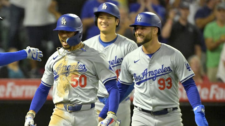 Sep 3, 2024; Anaheim, California, USA; Los Angeles Dodgers shortstop Mookie Betts (50) celebrates after hitting a three-run home run scoring designated hitter Shohei Ohtani (17) and center fielder Kevin Kiermaier (93) in the tenth inning against the Los Angeles Angels at Angel Stadium. Mandatory Credit: Jayne Kamin-Oncea-Imagn Images Sep 3, 2024; Anaheim, California, USA; Los Angeles Dodgers shortstop Mookie Betts (50) celebrates after hitting a three-run home run scoring designated hitter Shohei Ohtani (17) and center fielder Kevin Kiermaier (93) in the tenth inning against the Los Angeles Angels at Angel Stadium. Mandatory Credit: Jayne Kamin-Oncea-Imagn Images