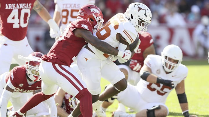 Texas Longhorns running back Quintrevion Wisner (26) is tackled during the first quarter by Arkansas Razorbacks linebacker Xavian Sorey Jr. (10) at Donald W. Reynolds Razorback Stadium.