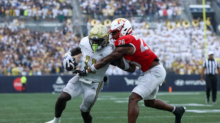 Sep 14, 2024; Atlanta, Georgia, USA; Georgia Tech Yellow Jackets running back Jamal Haynes (11) has the ball stripped by Virginia Military Institute Keydets defensive back Kouri Crump (26) in the second quarter at Bobby Dodd Stadium at Hyundai Field. Mandatory Credit: Brett Davis-Imagn Images
