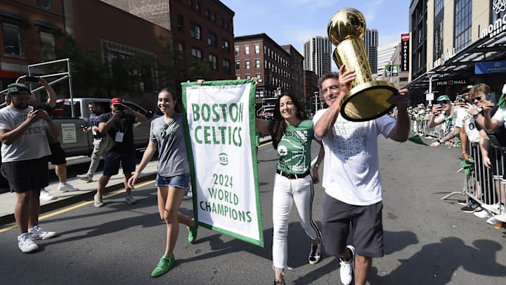 Jun 21, 2024; Boston, MA, USA;  Boston Celtics majority owner Wyc Grousbeck carries the Larry OíBrien trophy prior to the Boston Celtics championship parade. Mandatory Credit: Bob DeChiara-Imagn Images