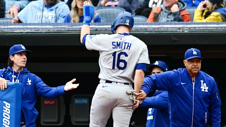 May 28, 2025; Cleveland, Ohio, USA; Los Angeles Dodgers catcher Will Smith (16) celebrates after scoring with manager Dave Roberts, right, during the fourth inning against the Cleveland Guardians at Progressive Field. Mandatory Credit: Ken Blaze-Imagn Images