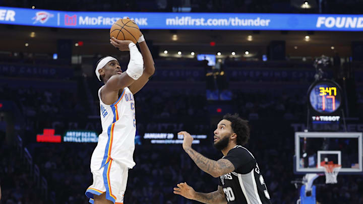 Dec 25, 2025; Oklahoma City, Oklahoma, USA; Oklahoma City Thunder guard Shai Gilgeous-Alexander (2) shoots a three point basket over San Antonio Spurs forward Julian Champagnie (30) during the second half at Paycom Center. Mandatory Credit: Alonzo Adams-Imagn Images
