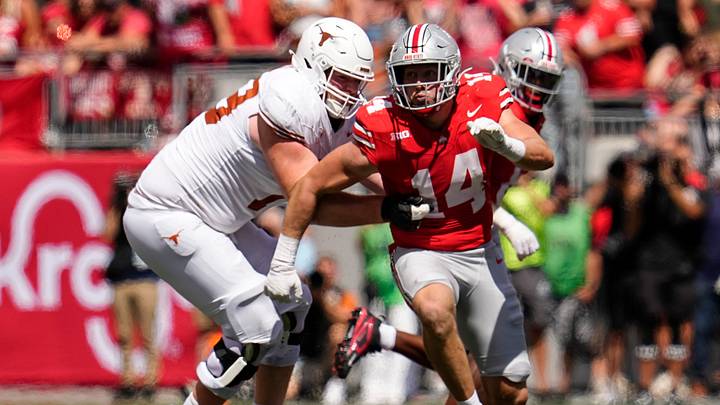 Ohio State Buckeyes defensive lineman Beau Atkinson (14) runs past Texas Longhorns offensive lineman Connor Stroh (79) during the NCAA football game at Ohio Stadium on Aug. 30, 2025. Ohio State Buckeyes defensive lineman Beau Atkinson (14) runs past Texas Longhorns offensive lineman Connor Stroh (79) during the NCAA football game at Ohio Stadium on Aug. 30, 2025.