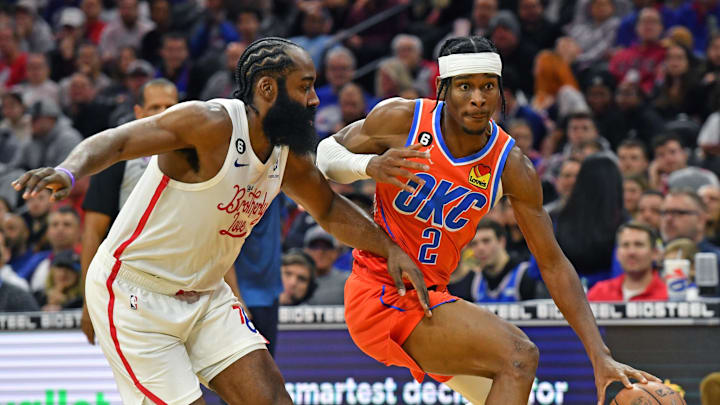 Jan 12, 2023; Philadelphia, Pennsylvania, USA; Oklahoma City Thunder guard Shai Gilgeous-Alexander (2) drives to the basket against Philadelphia 76ers guard James Harden (1) during the third quarter at Wells Fargo Center. Mandatory Credit: Eric Hartline-Imagn Images