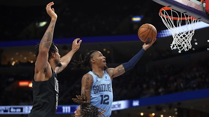 Dec 13, 2024; Memphis, Tennessee, USA; Memphis Grizzlies guard Ja Morant (12) drives to the basket during the fourth quarter against the Brooklyn Nets at FedExForum. Mandatory Credit: Petre Thomas-Imagn Images Dec 13, 2024; Memphis, Tennessee, USA; Memphis Grizzlies guard Ja Morant (12) drives to the basket during the fourth quarter against the Brooklyn Nets at FedExForum. Mandatory Credit: Petre Thomas-Imagn Images