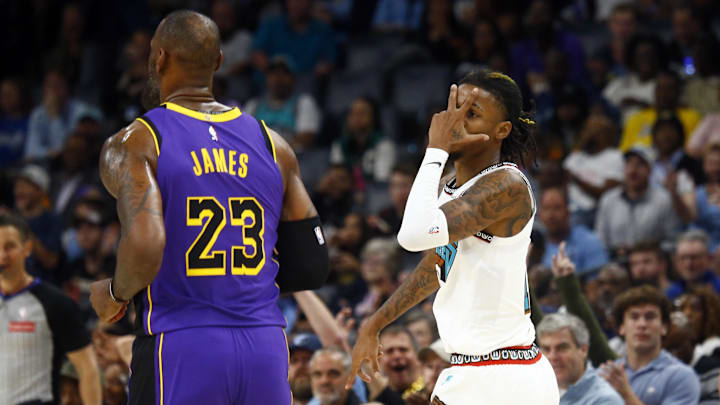 Memphis Grizzlies guard Ja Morant (12) reacts toward Los Angeles Lakers forward LeBron James (23) after a three point basket during the first half at FedExForum. Mandatory Credit: Petre Thomas-Imagn Images