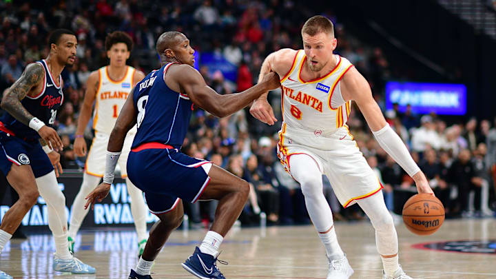 Nov 10, 2025; Inglewood, California, USA; Atlanta Hawks center Kristaps Porzingis (8) moves to the basket against Los Angeles Clippers guard Kris Dunn (8) during the second half at Intuit Dome. Mandatory Credit: Gary A. Vasquez-Imagn Images
