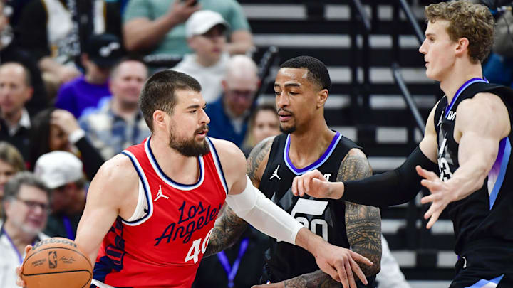 Feb 13, 2025; Salt Lake City, Utah, USA; LA Clippers center Ivica Zubac (40) turns into Utah Jazz forward/center John Collins (20) and forward/center Lauri Markkanen (23) during the first half at the Delta Center. Mandatory Credit: Christopher Creveling-Imagn Images