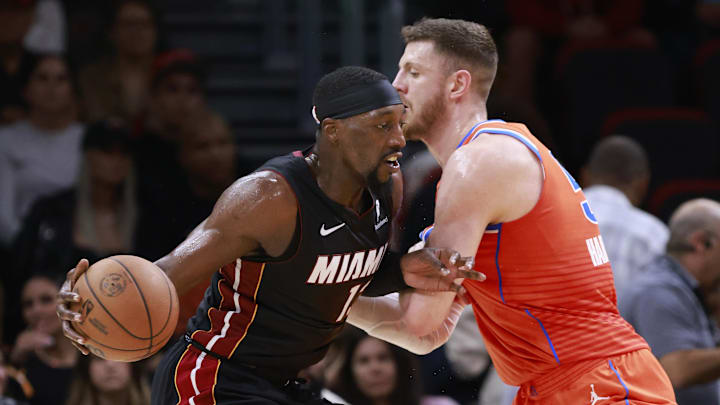 Dec 20, 2024; Miami, Florida, USA;  Oklahoma City Thunder center Isaiah Hartenstein (55) defends Miami Heat center Bam Adebayo (13) during the first half at Kaseya Center. Mandatory Credit: Rhona Wise-Imagn Images